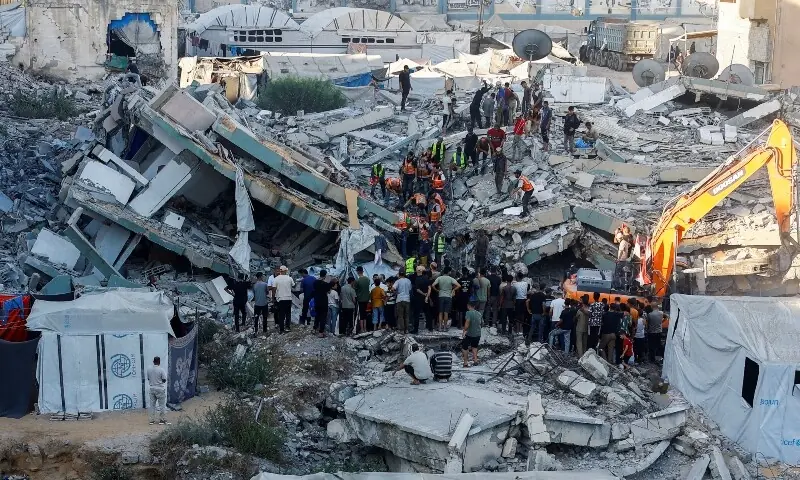 Bombed-out Gaza building collapses, killing 12 people seeking shelter inside
